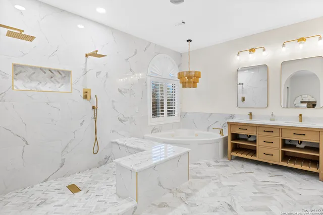 a bathroom with a tub sink and mirror