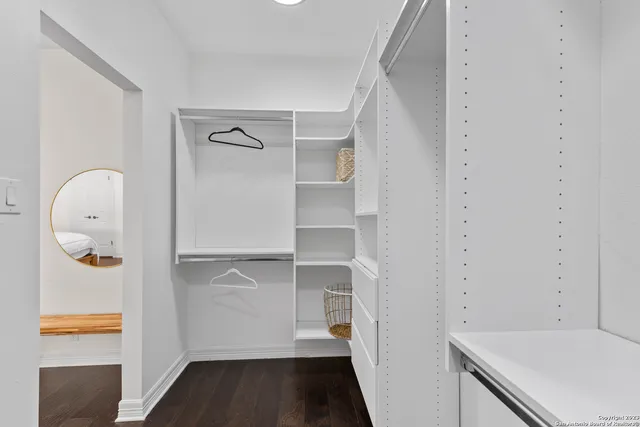 a view of walk in closet with empty racks