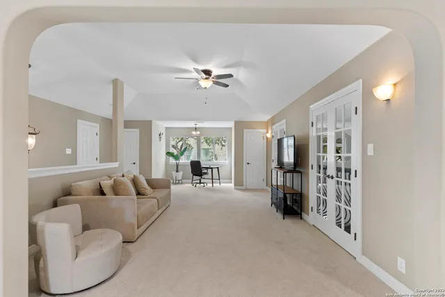 a living room with furniture and a large window