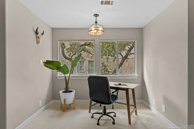 a dining room with furniture a potted plant and a chandelier
