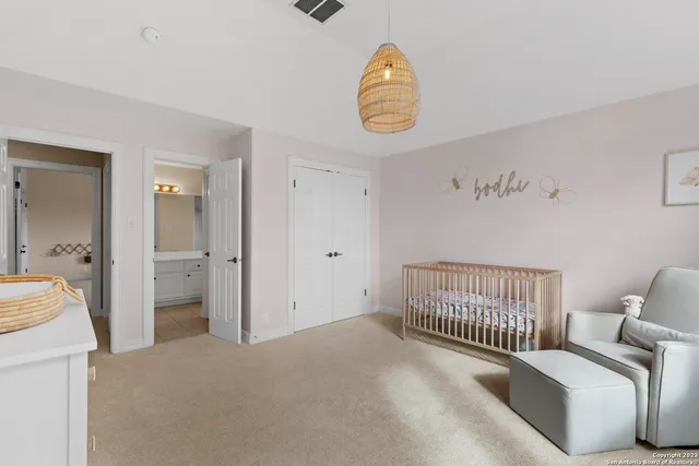 a view of a bedroom with a bed and wooden floor