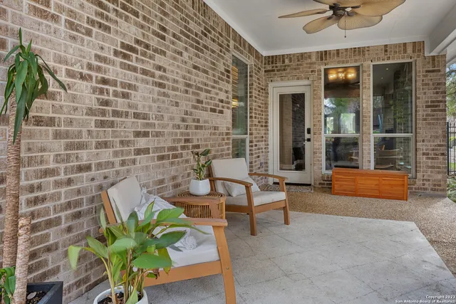 a view of a patio with table and chairs and potted plants