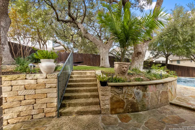 a view of a fountain in the backyard of house