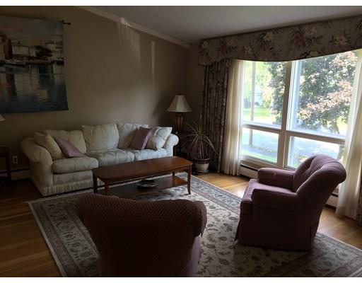 28 Peterson Road Natick, MA 01760 - Photo 18 of 30 a living room with furniture and a floor to ceiling window