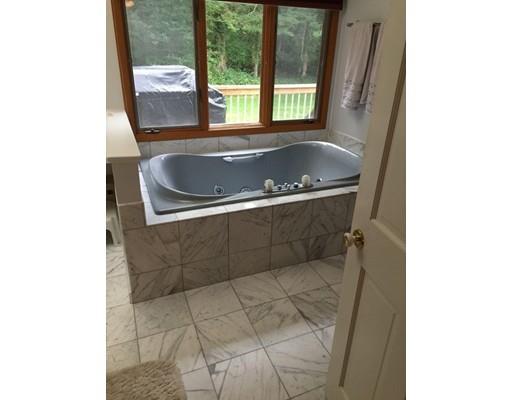 28 Peterson Road Natick, MA 01760 - Photo 23 of 30 a bath tub sitting in a bathroom next to a window
