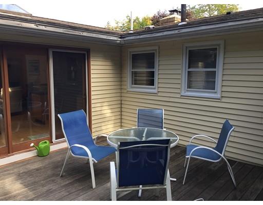 28 Peterson Road Natick, MA 01760 - Photo 6 of 30 a patio with table and chairs and potted plants