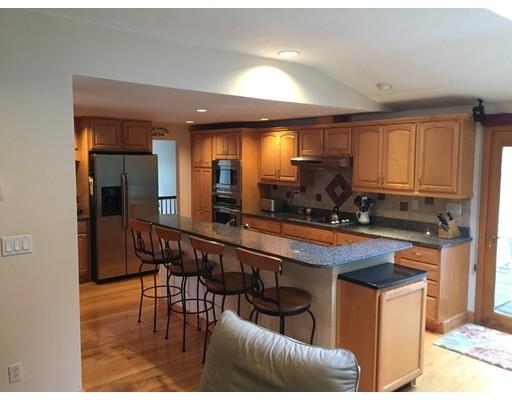 28 Peterson Road Natick, MA 01760 - Photo 9 of 30 a kitchen with stainless steel appliances granite countertop a sink and a refrigerator