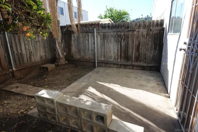 a view of a backyard with wooden fence
