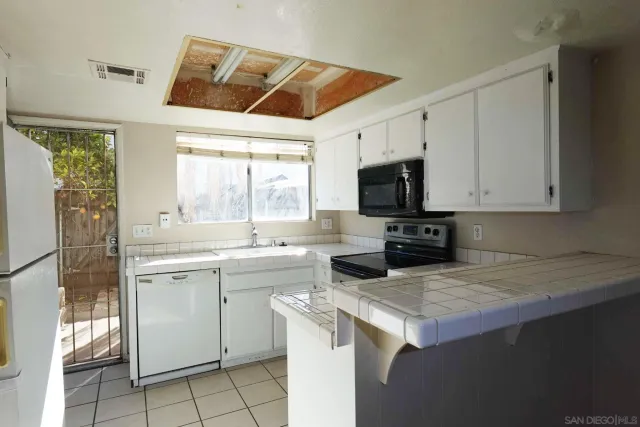 a kitchen with a stove a sink and a refrigerator