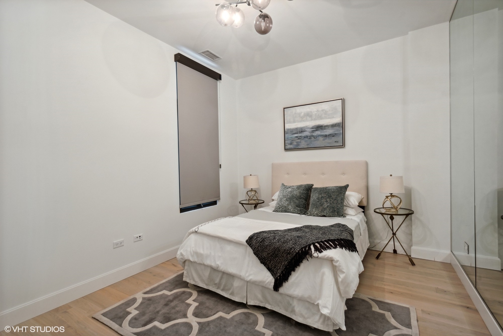 36 North Carpenter Street, Unit 2N Chicago, IL 60607 - Photo 16 of 25 a bedroom with a bed and a night stand