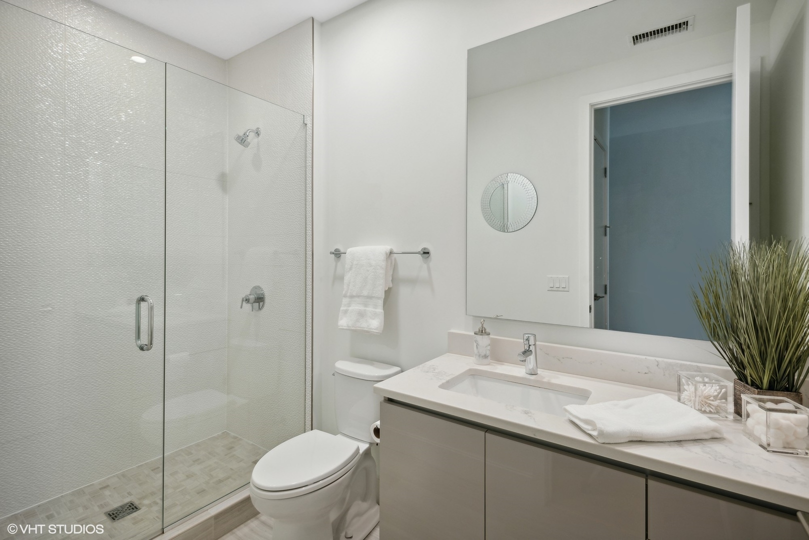 36 North Carpenter Street, Unit 2N Chicago, IL 60607 - Photo 17 of 25 a bathroom with a granite countertop sink a toilet and shower
