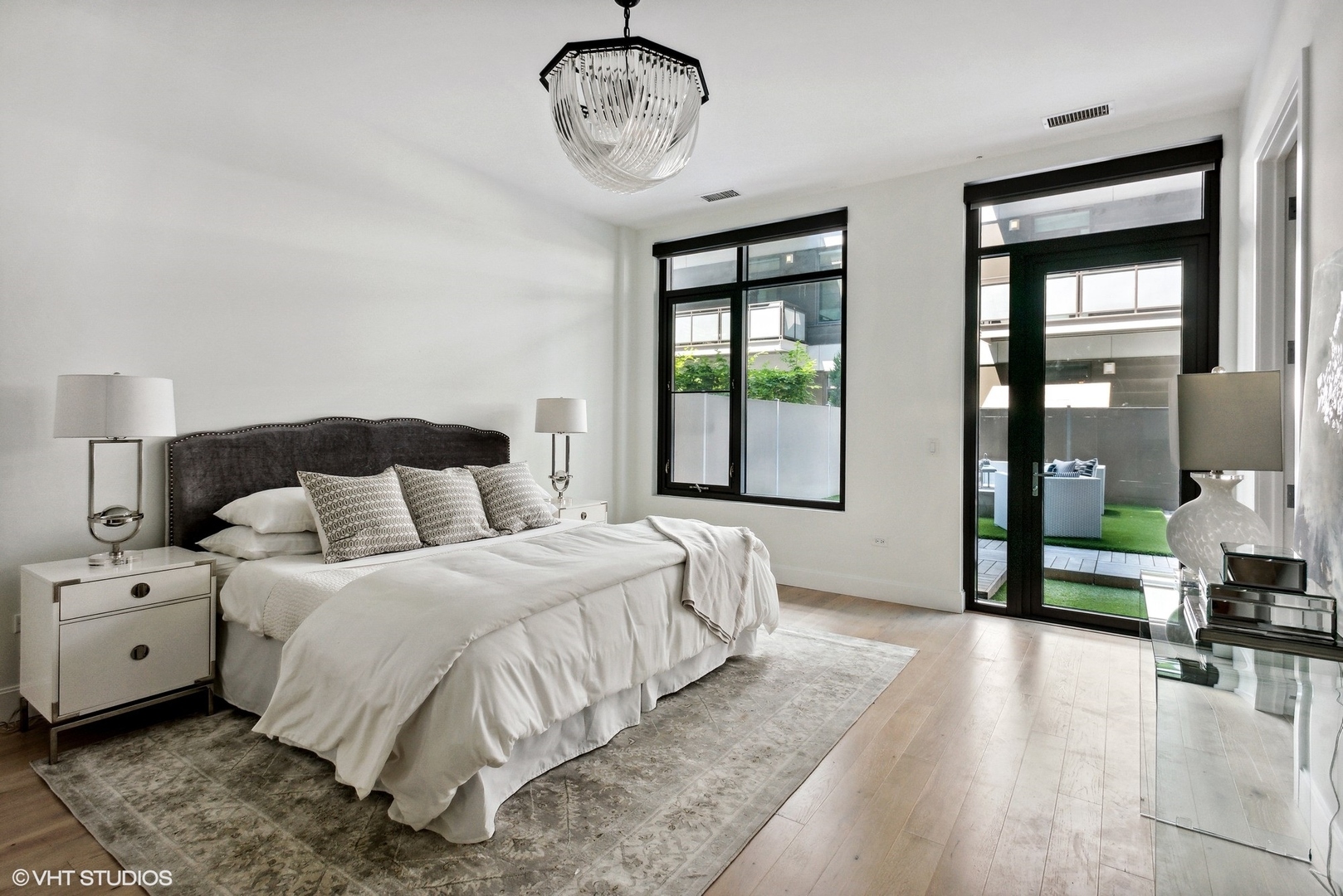 36 North Carpenter Street, Unit 2N Chicago, IL 60607 - Photo 19 of 25 a bedroom with a large bed and a chandelier