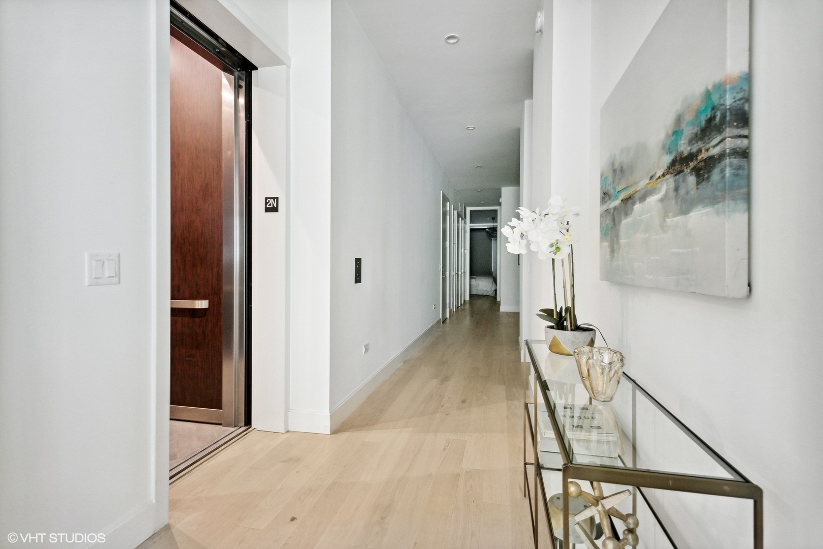 36 North Carpenter Street, Unit 2N Chicago, IL 60607 - Photo 2 of 25 a view of hallway with furniture and a chandelier