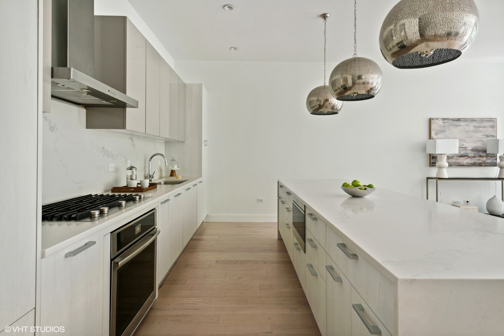 36 North Carpenter Street, Unit 2N Chicago, IL 60607 - Photo 10 of 25 a kitchen with a stove and a wooden floor