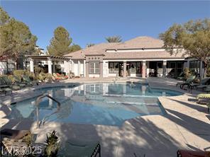 7255 West Sunset Road, Unit 2046 Las Vegas, NV 89113 - Photo 26 of 28 An inviting outdoor pool with ample lounging space complements the elegant community clubhouse.