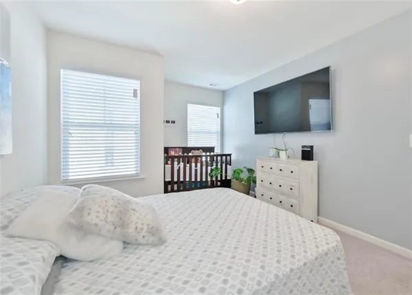 a bedroom with a bed and flat screen tv