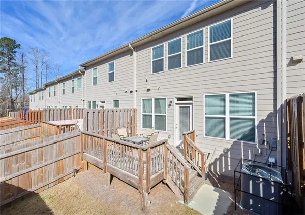 a view of a house with a wooden deck