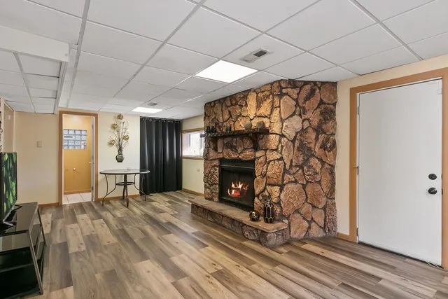 a view of an empty room with a fireplace and a window