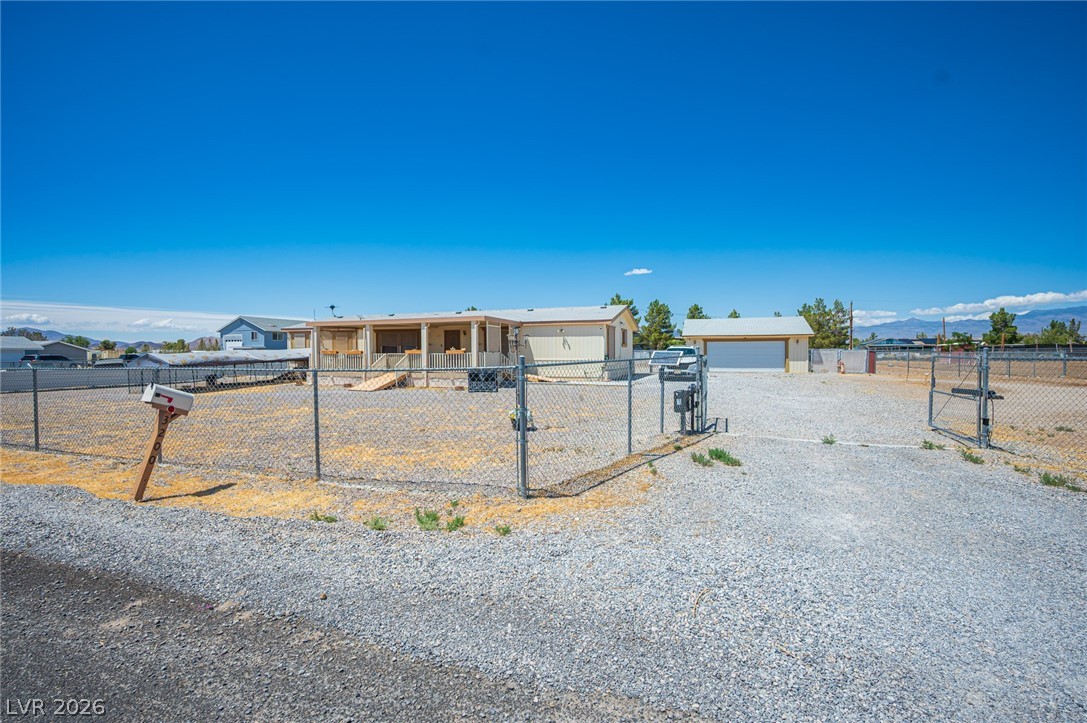 3200 Maple Road Pahrump, NV 89048 - Photo 2 of 53 A fully fenced property offers privacy and security with a detached garage and mountain views.