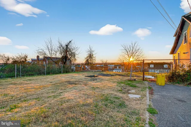 a view of the house with backyard and garden