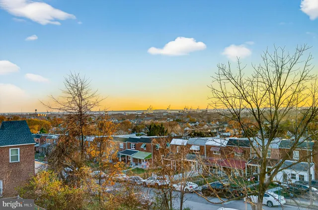 a view of a hallway with wooden floor and closet