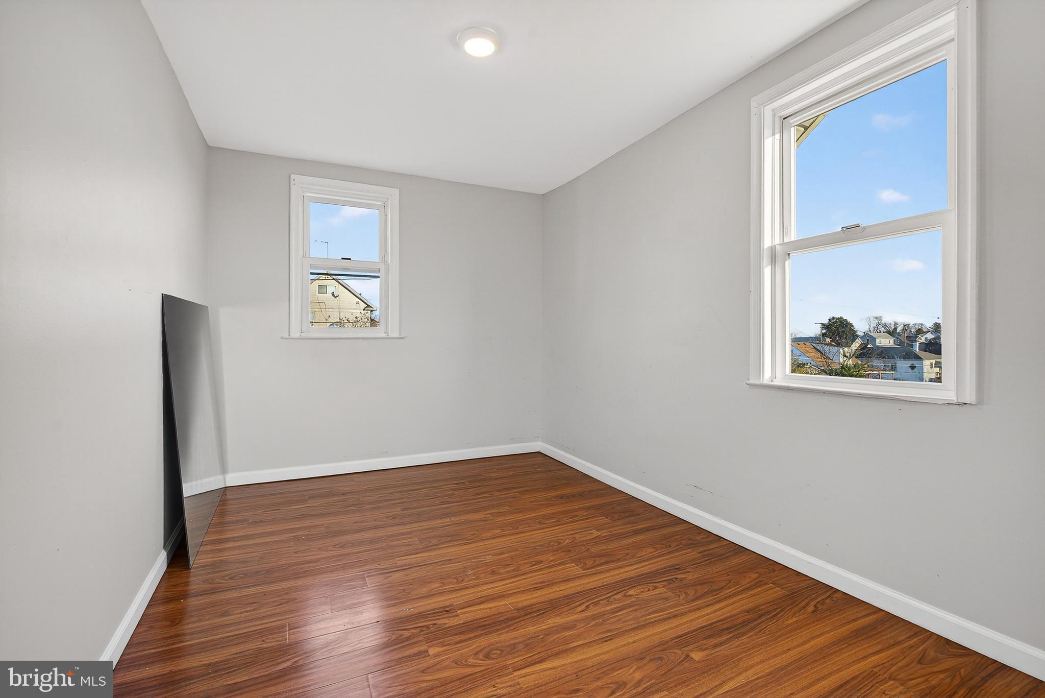 511 47th Street Baltimore, MD 21224 - Photo 16 of 44 a view of an empty room with wooden floor and a window