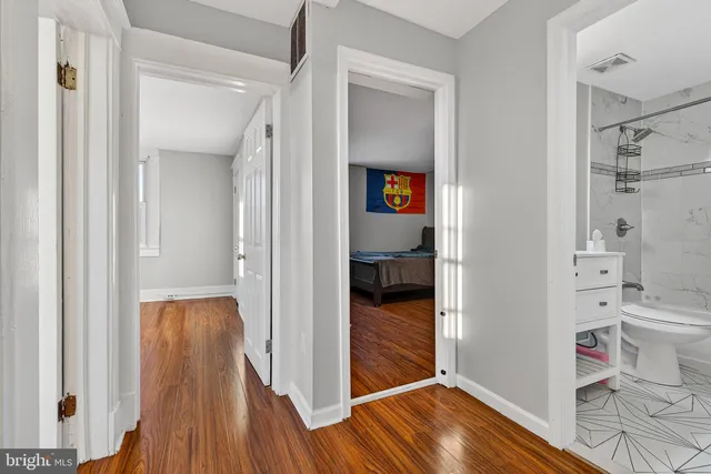 a view of a room with wooden floor