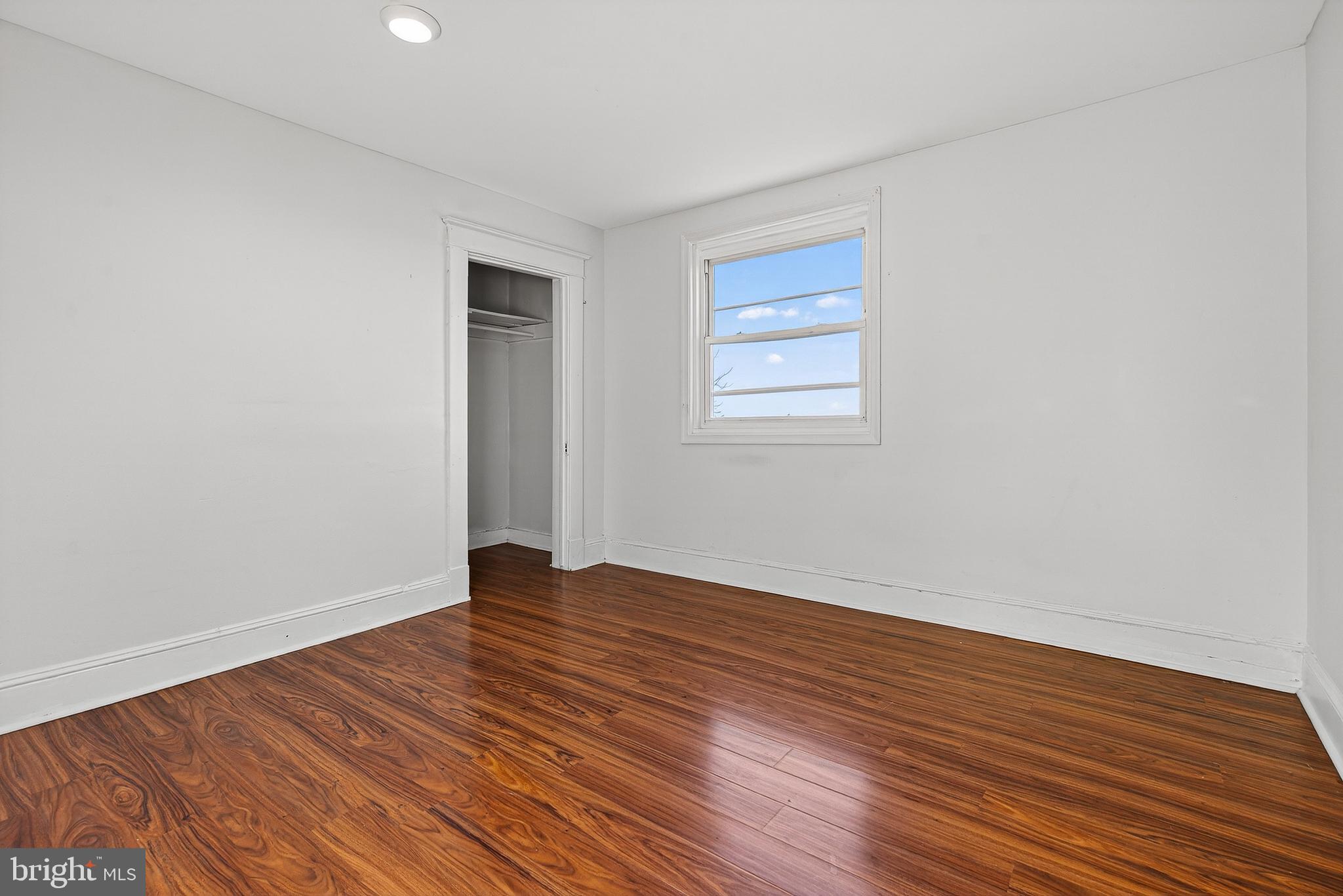 511 47th Street Baltimore, MD 21224 - Photo 20 of 44 a view of an empty room with wooden floor and a window