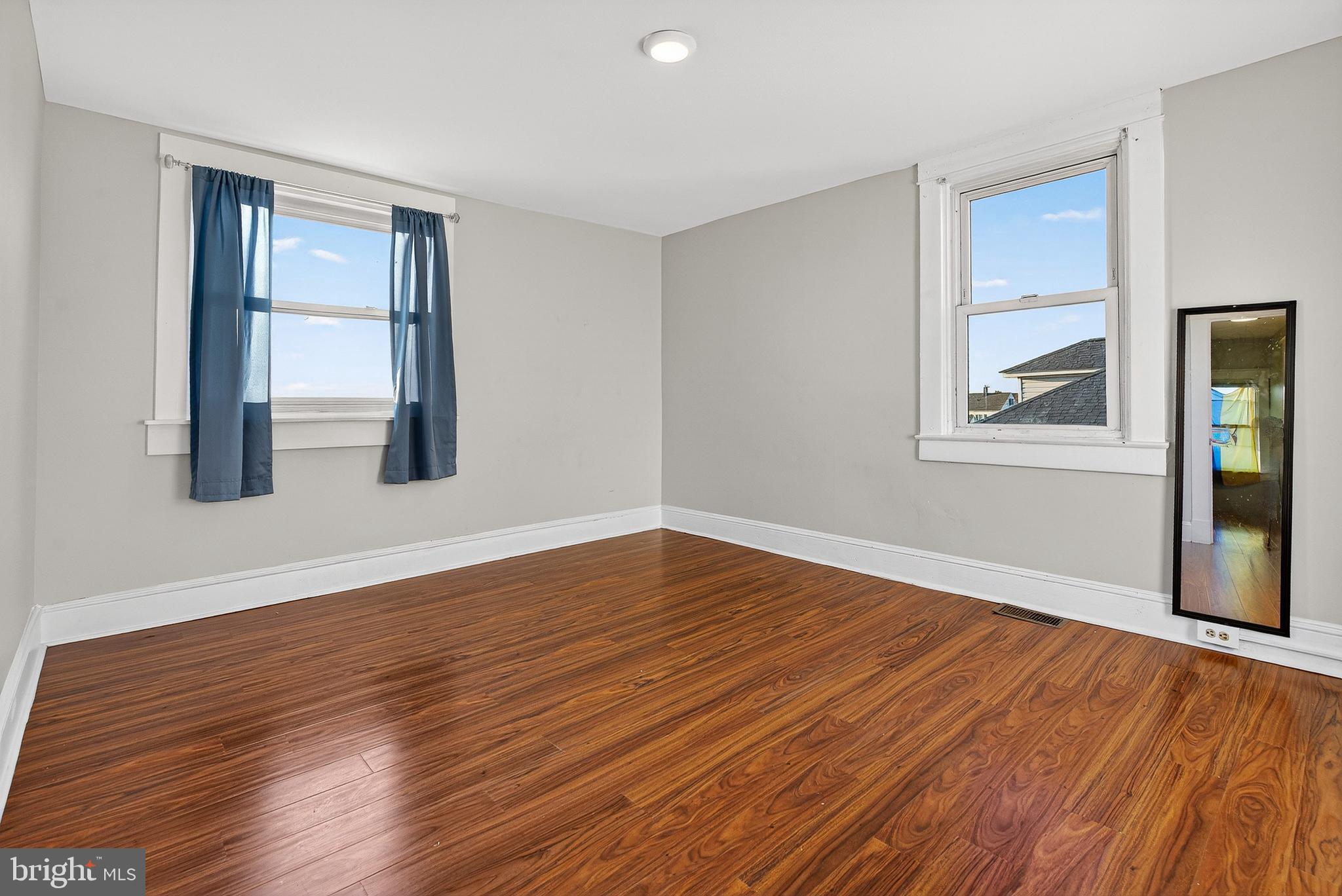 511 47th Street Baltimore, MD 21224 - Photo 22 of 44 a view of an empty room with wooden floor and a window