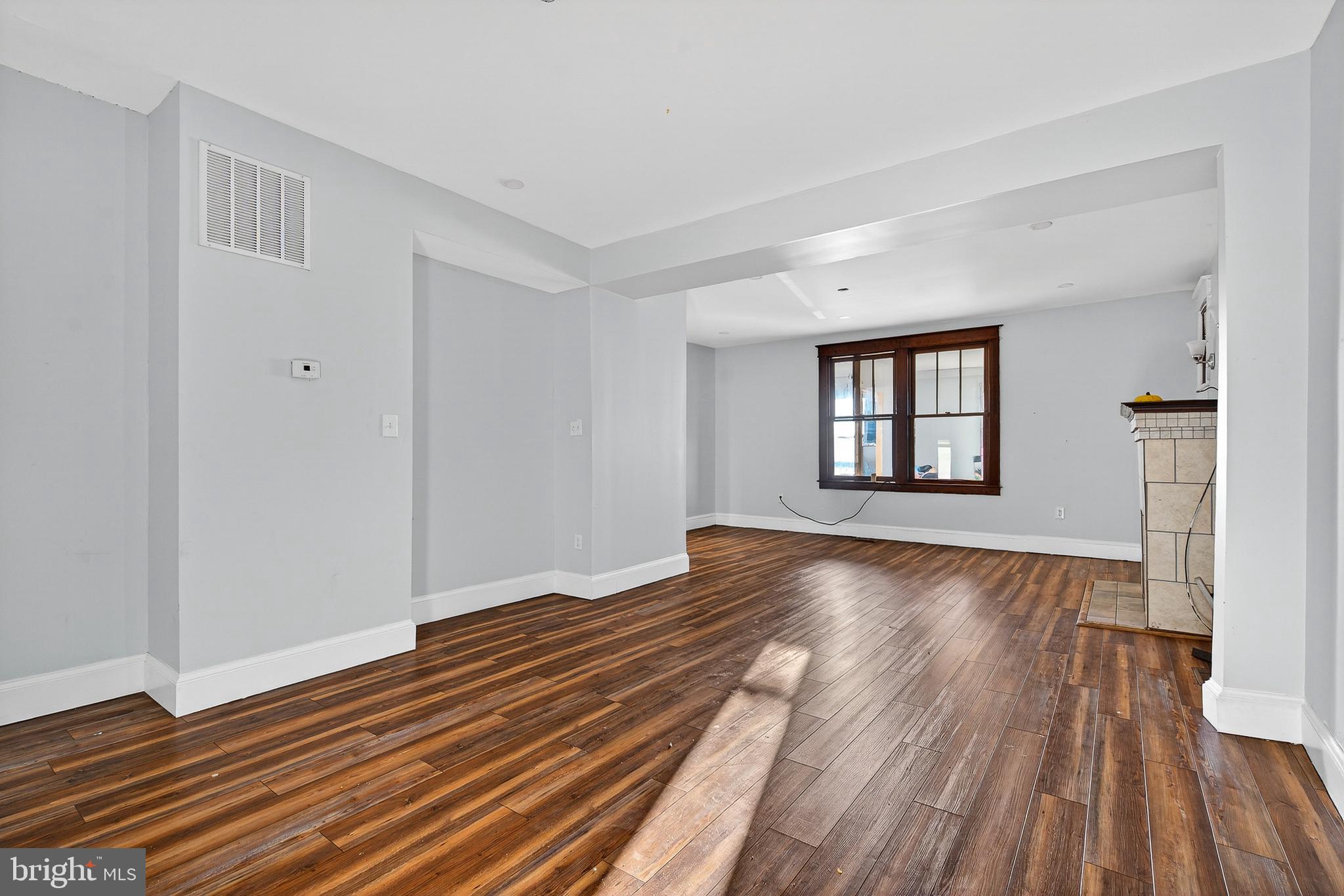 511 47th Street Baltimore, MD 21224 - Photo 25 of 44 a view of an empty room with wooden floor and a window