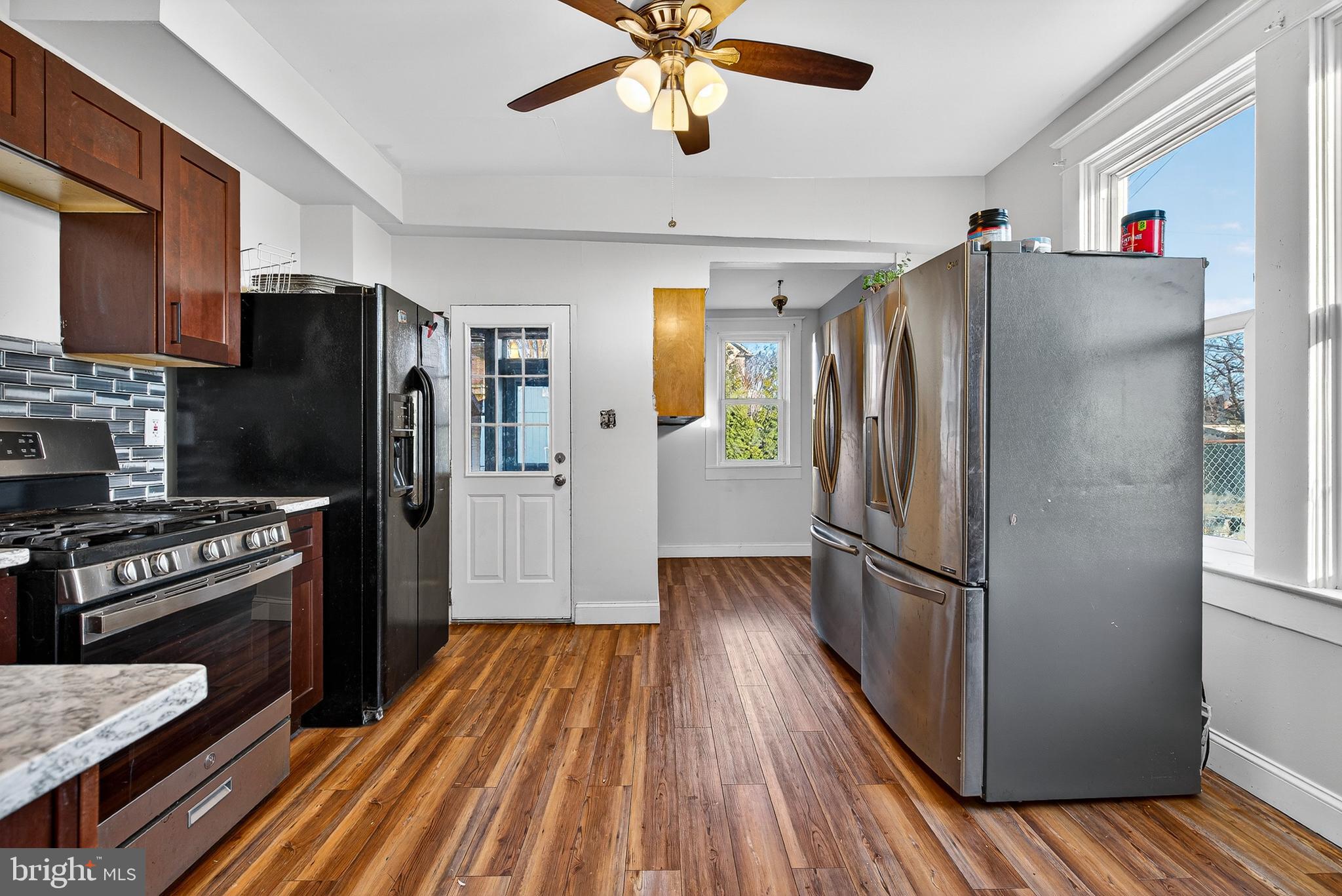 511 47th Street Baltimore, MD 21224 - Photo 30 of 44 a kitchen with stainless steel appliances a refrigerator and a stove