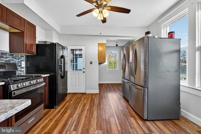 a view of an entryway with wooden floor and windows