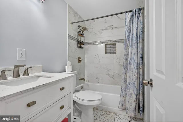 a metallic refrigerator freezer sitting in a room