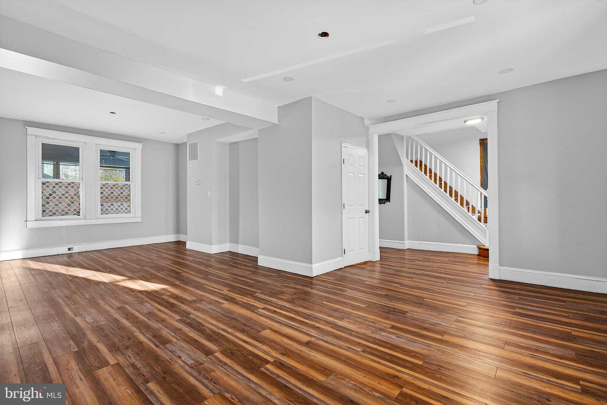 511 47th Street Baltimore, MD 21224 - Photo 4 of 44 a view of an empty room with wooden floor and stairs