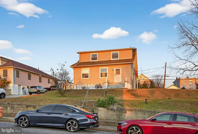 a kitchen with stainless steel appliances granite countertop a refrigerator a stove and a sink with wooden floor
