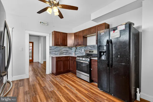 a kitchen with stainless steel appliances granite countertop a stove a refrigerator and a sink