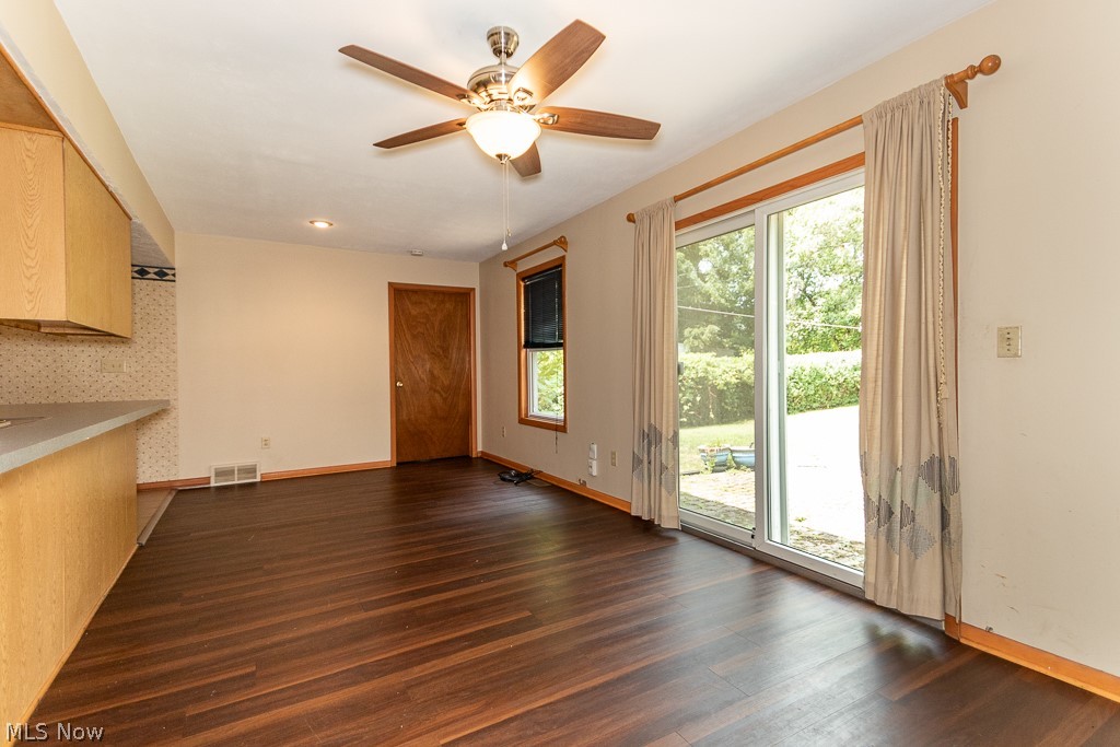 4517 Mackall Road Cleveland, OH 44121 - Photo 23 of 41 Unfurnished living room featuring ceiling fan, dark hardwood / wood-style flooring, and plenty of natural light