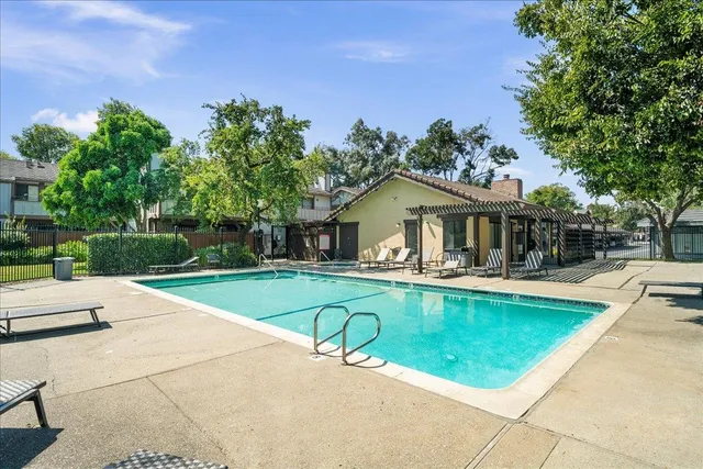 a view of a house with swimming pool and sitting area
