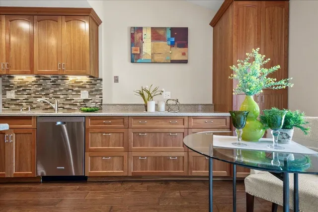 a dining room with table chairs and wooden floor