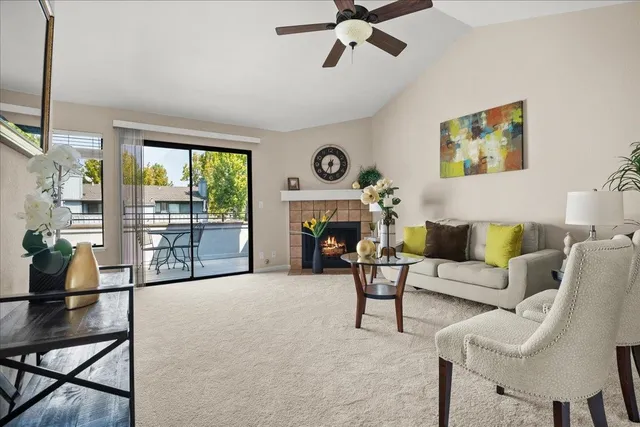 a living room with furniture and a floor to ceiling window
