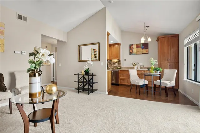 a view of a dining room with furniture and chandelier