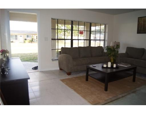 1651 North Cypress Road Pompano Beach, FL 33060 - Photo 3 of 12 a living room with furniture and a large window