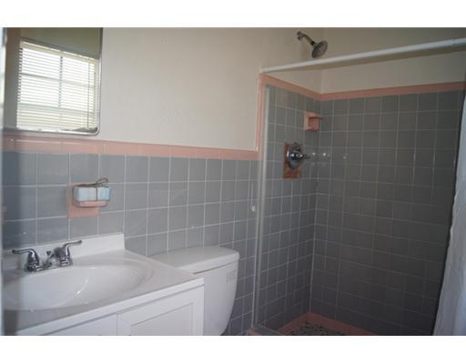 1651 North Cypress Road Pompano Beach, FL 33060 - Photo 9 of 12 a bathroom with a sink a toilet and a mirror