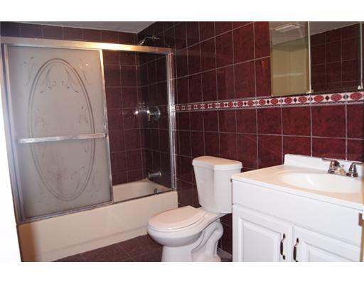 1651 North Cypress Road Pompano Beach, FL 33060 - Photo 10 of 12 a bathroom with a sink a toilet and shower