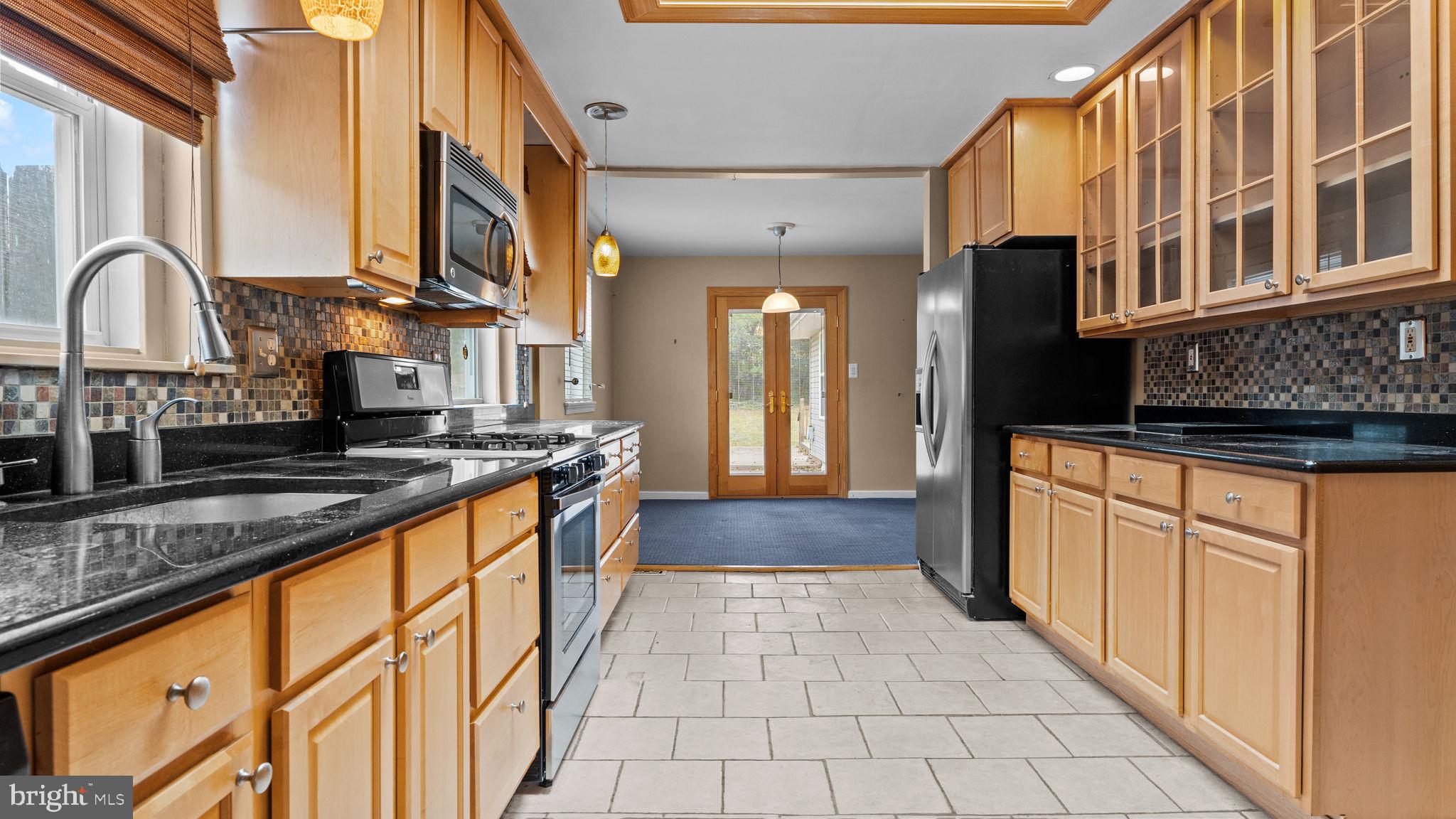 69 Crooked Billet Road Hatboro, PA 19040 - Photo 2 of 33 a kitchen with stainless steel appliances granite countertop a stove a sink and a microwave