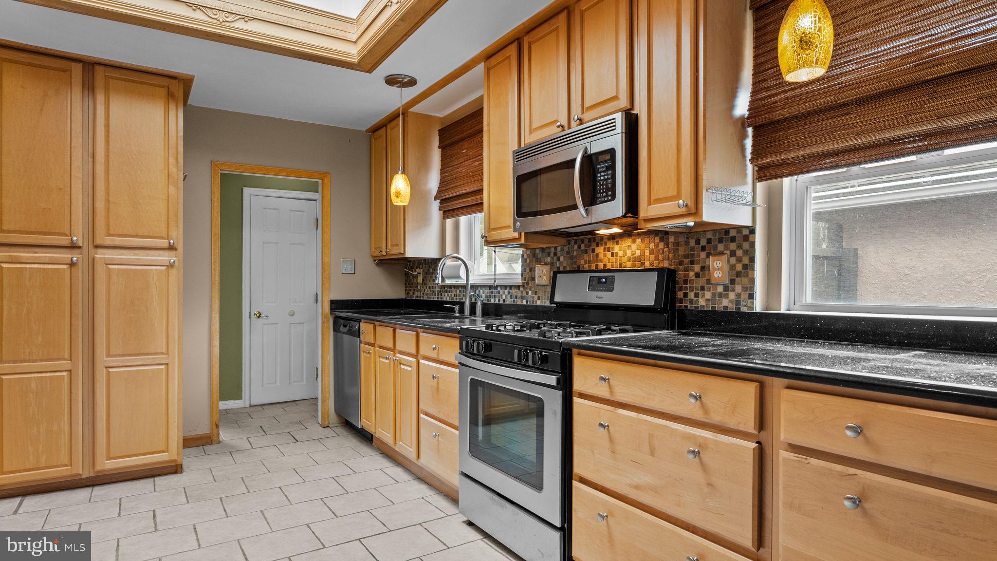 69 Crooked Billet Road Hatboro, PA 19040 - Photo 3 of 33 a kitchen with stainless steel appliances granite countertop a stove and a microwave