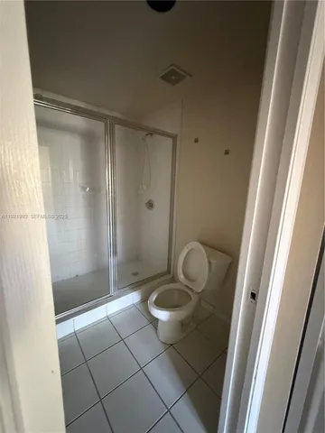 a bathroom with a granite countertop shower and a sink