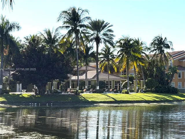 a view of swimming pool with palm trees