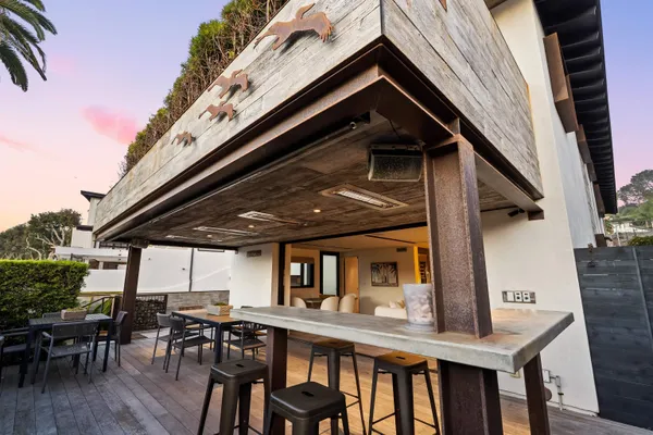 a view of a dinning table and chairs in patio of the house