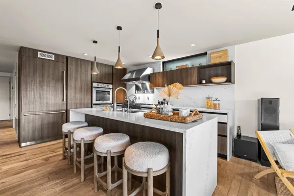 a open kitchen with stainless steel appliances granite countertop a stove and a sink